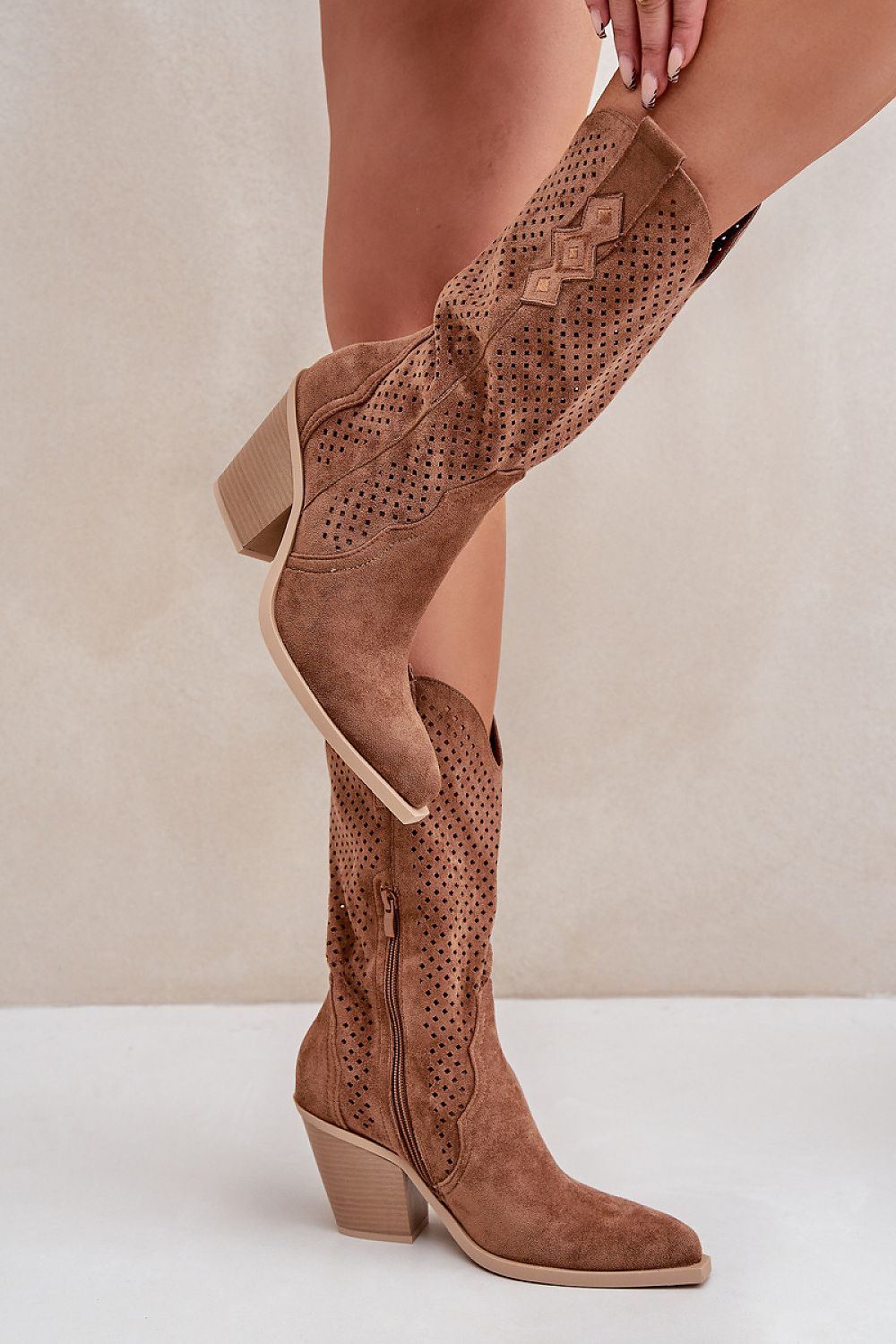 Rinvara latticed cowboy boots in brown suede with block heel, side zipper, and pointed toe, showcasing stylish lattice design.
