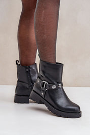 Woman wearing Varita Everyday Ankle Boots with decorative straps and side zipper for casual cold-weather style.