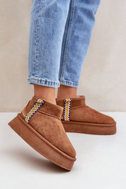 Azmira Aztec platform snow boots with eco suede and plush fur lining, featuring Aztec-inspired pattern, worn with jeans.