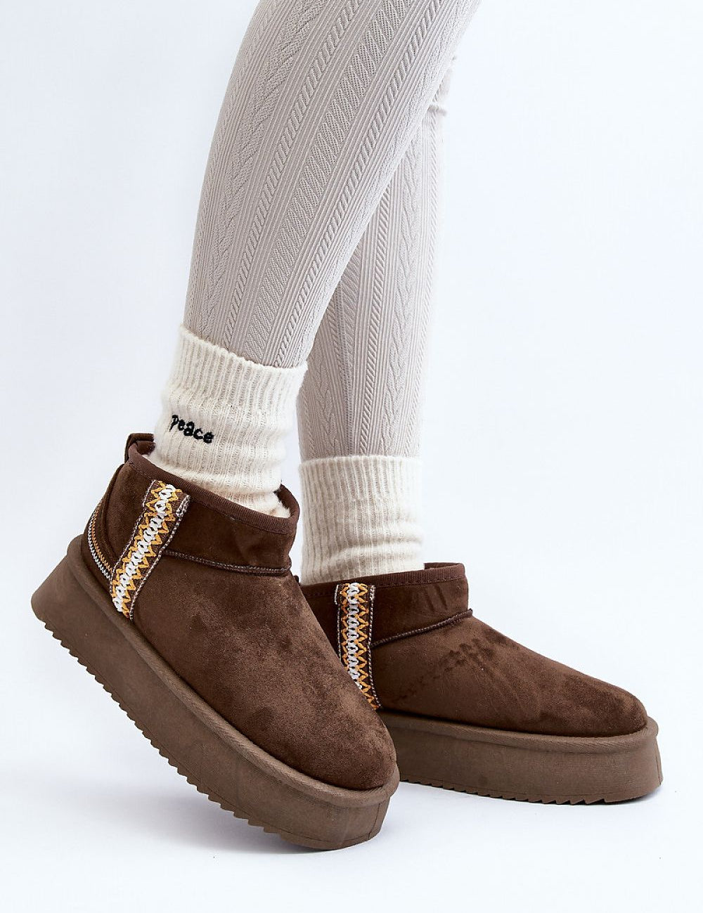 Azmira Aztec Platform Snow Boots in brown eco suede with Aztec pattern, thick platform for warmth, worn with white socks, side view.
