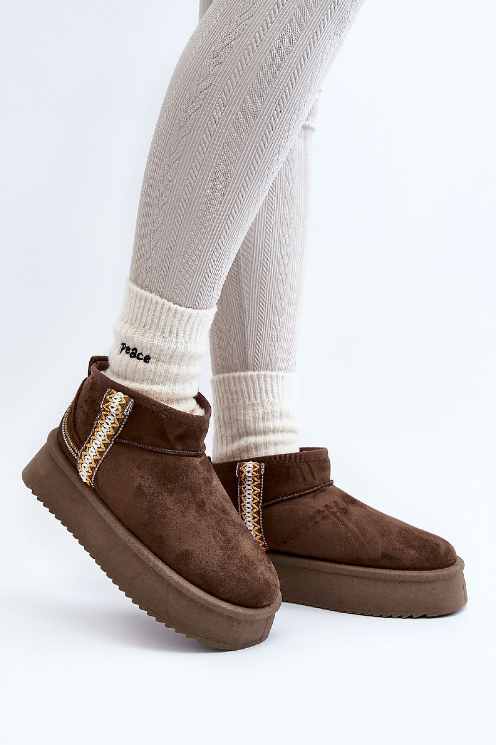 Azmira Aztec Platform Snow Boots in brown eco suede with Aztec pattern, thick platform for warmth, worn with white socks, side view.