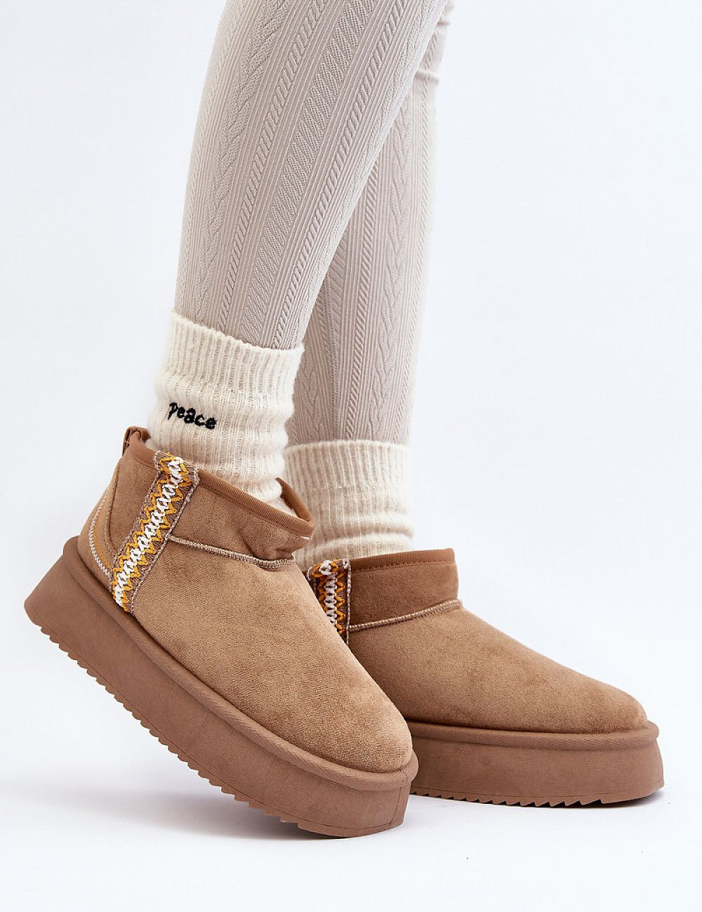 Azmira Aztec Platform Snow Boots on feet, featuring eco suede, plush fur lining, and Aztec pattern, perfect for winter citywear.