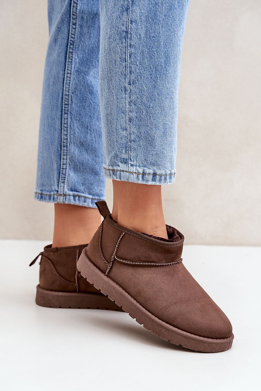 Woman wearing Morvenna Fur-Lined Suede Snow Boots with jeans, showcasing eco suede material and cozy fur lining for winter wear.