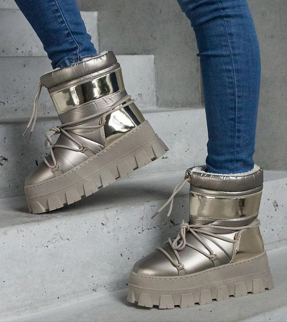 Person wearing Zolarin Platform Lace-Up Snow Boots with golden inserts and chunky platform on concrete steps.