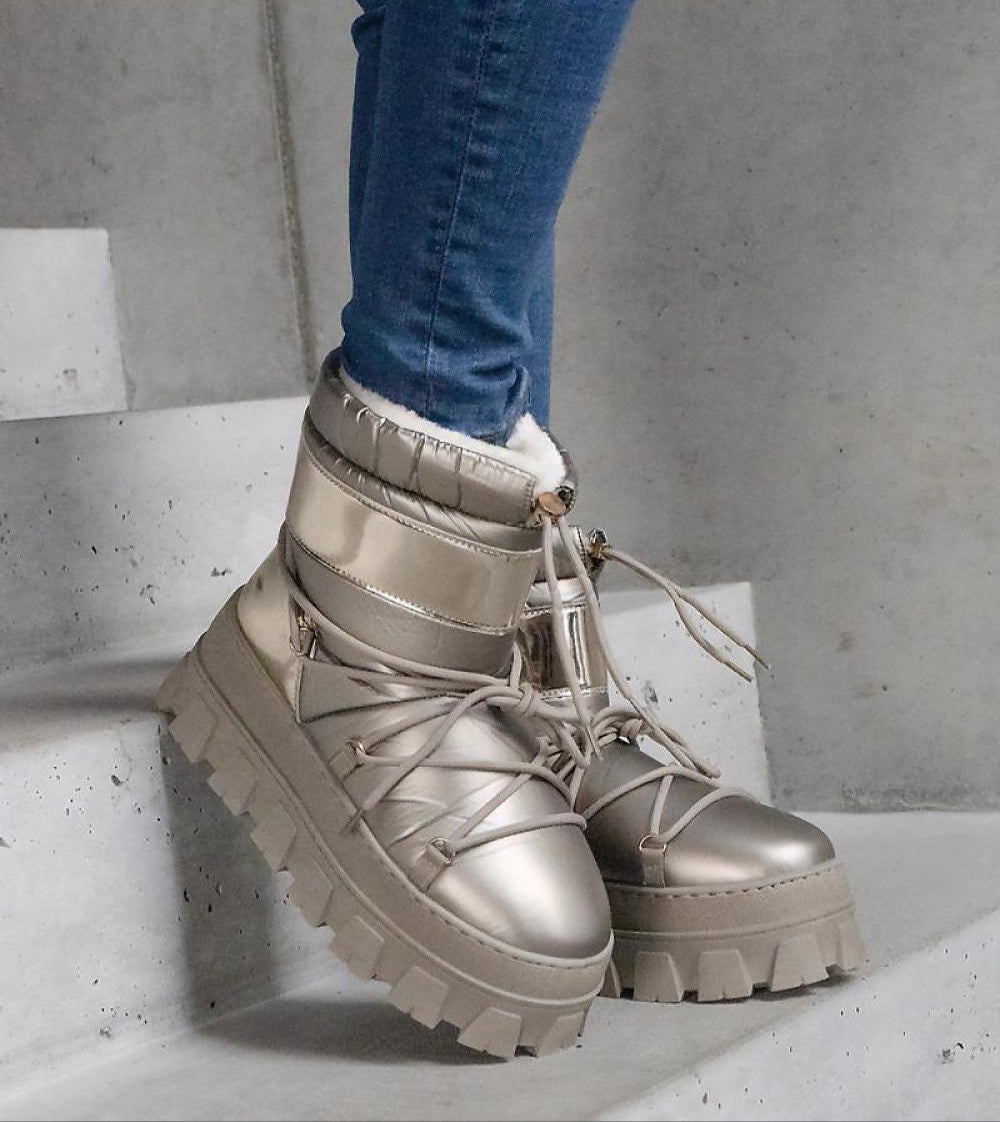 Stylish golden platform lace-up snow boots with round toe and high shaft, designed for warmth and durable winter wear.