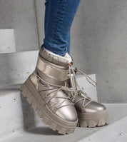 Stylish golden platform lace-up snow boots with round toe and high shaft, designed for warmth and durable winter wear.