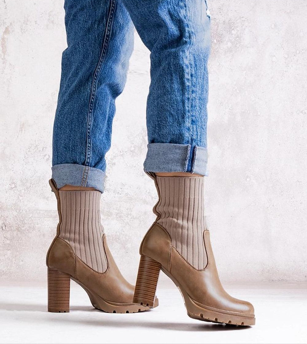 Woman wearing Nuvarelle Stiletto Ankle Boots with jeans, showcasing elegant insulated design and 9cm heel for autumn fashion.