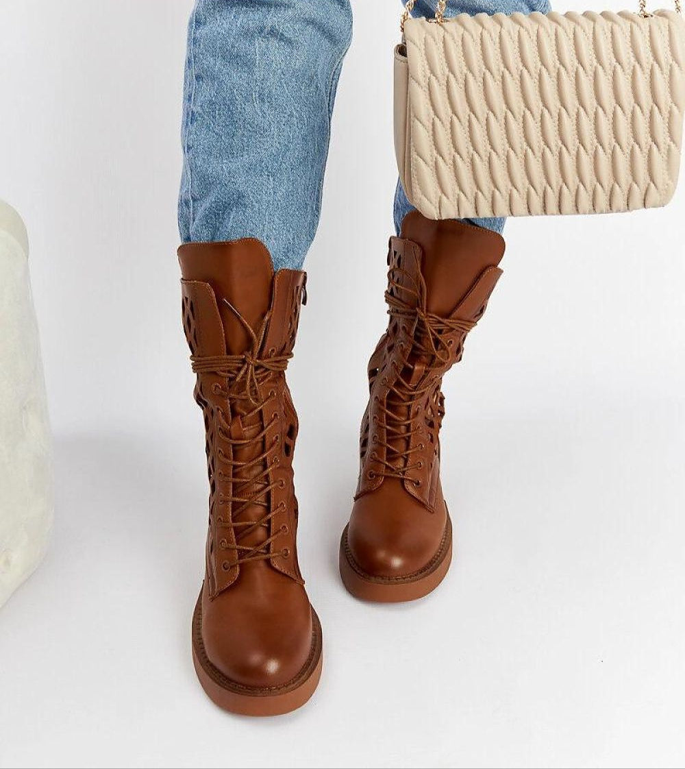 Person wearing Zenvaira Laced Winter Ankle Boots in brown eco leather with jeans, carrying a cream handbag.