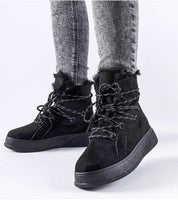 Black Darnelle Platform Winter Snow Boots with fur trim and thick sole, worn by model with grey jeans, ideal for winter weather.