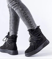 Person wearing Darnelle Platform Winter Snow Boots with 4 cm platform, eco leather, and insulated lining for cold weather protection.