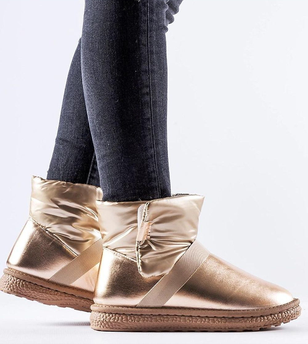 Brivona Glossy Velcro Snow Boots in gold with rounded toe and platform, worn with dark jeans, ideal for stylish winter wear.