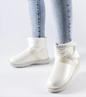 White Brivona Glossy Velcro Snow Boots worn with jeans, showcasing their stylish design, comfortable platform, and waterproof material.