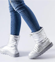 Person wearing Sylverra Slip-On Winter Snow Boots with futuristic design and waterproof sole, paired with blue jeans.