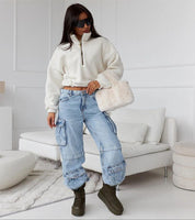 Woman in Olviera Slip-On Platform Snow Boots, wearing jeans and white pullover, holding a fluffy bag, stylish winter fashion ensemble.