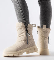Solvenya Quilted Zip Snow Boots with high shaft and side zipper, shown on person wearing jeans, offering warmth and comfort.