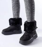 Black Cendara Zip-Up Winter Snow Boots with fur trim, worn with gray jeans, showcasing a warm, stylish option for cold climates.
