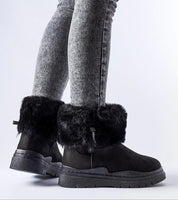 Cendara Zip-Up Winter Snow Boots with fur lining, side view showing sleek black design and textured heel, worn with gray jeans.