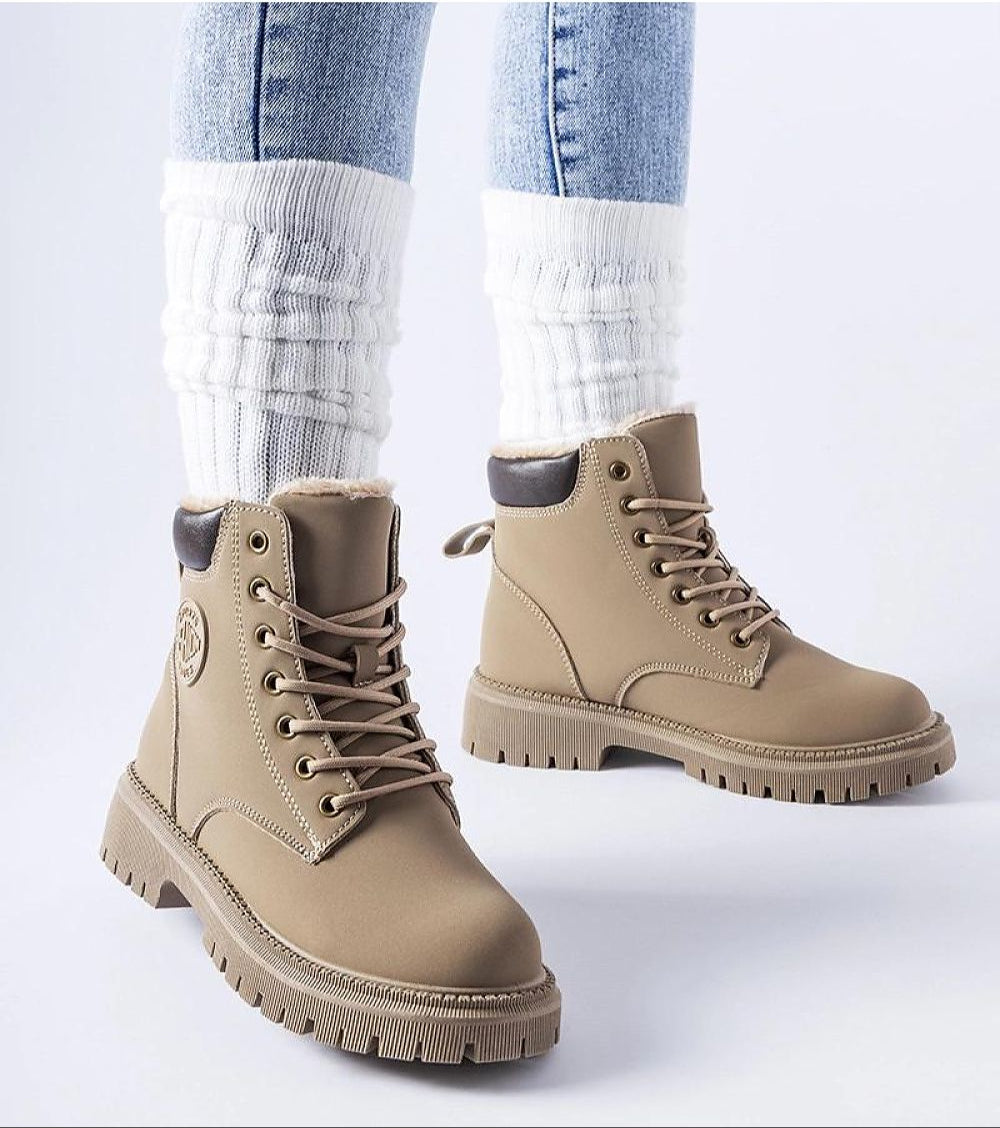Tharvain Insulated Trapper Boots with sturdy laced closure and thick sole, perfect for winter outings, paired with white leg warmers.