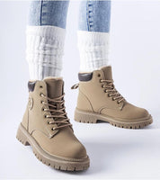 Tharvain Insulated Trapper Boots with sturdy laced closure and thick sole, perfect for winter outings, paired with white leg warmers.