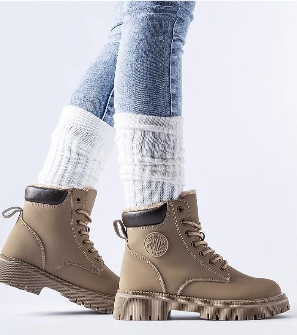 Tharvain insulated trapper boots with round toe and high-cut silhouette for winter, featuring thick rubber sole for grip.