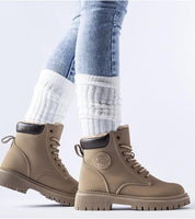 Tharvain insulated trapper boots with round toe and high-cut silhouette for winter, featuring thick rubber sole for grip.