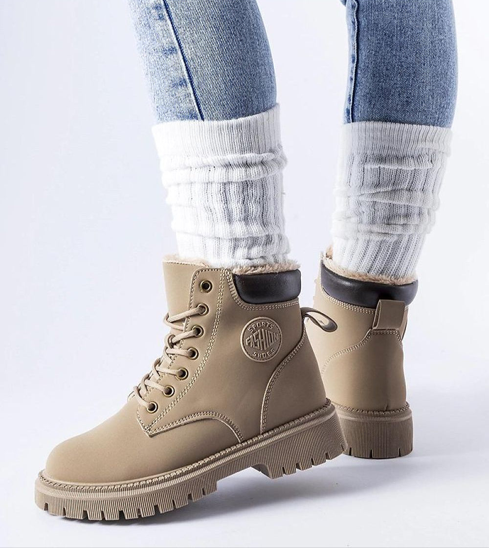 Tharvain Insulated Trapper Boots with round toe and high-cut silhouette, providing grip on icy streets; shown in beige with laces.