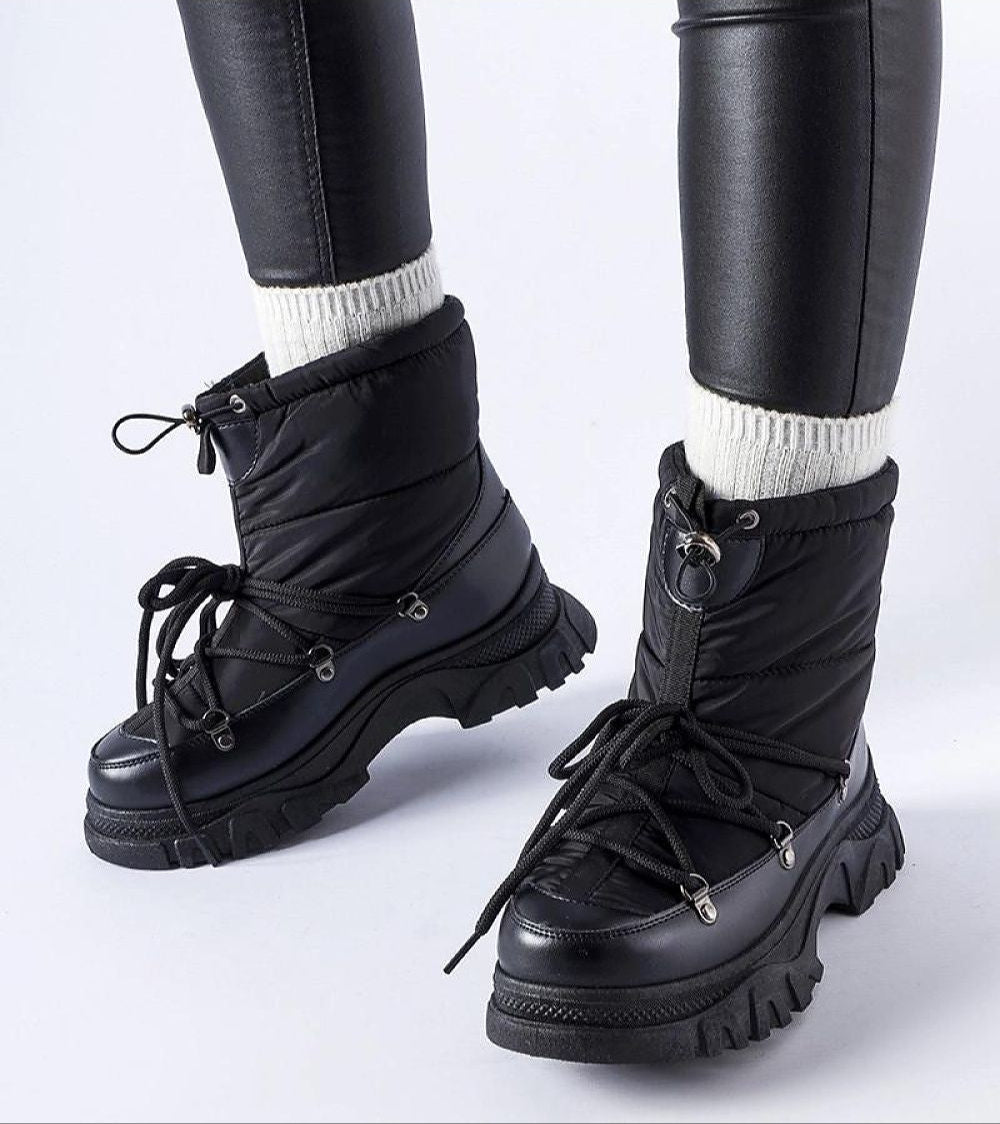 Eldarien Lace-Up Snow Boots with waterproof rubber outer and thermal lining, perfect for city or snowy strolls, shown worn with leggings.