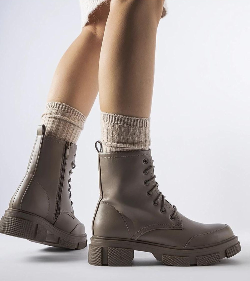 Alt Tag: Cavaryn insulated lace-up winter boots with ankle-high silhouette and rubber sole for urban and adventurous walks, side view.
