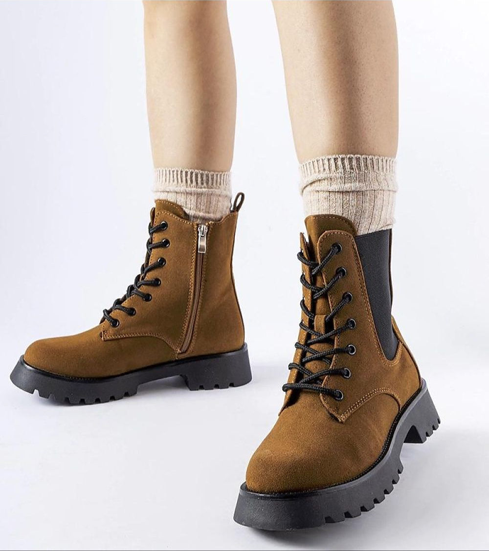 Person wearing Everleigh Ridge Winter Boots with chunky sole and eco-leather upper, featuring side zipper and adjustable laces.