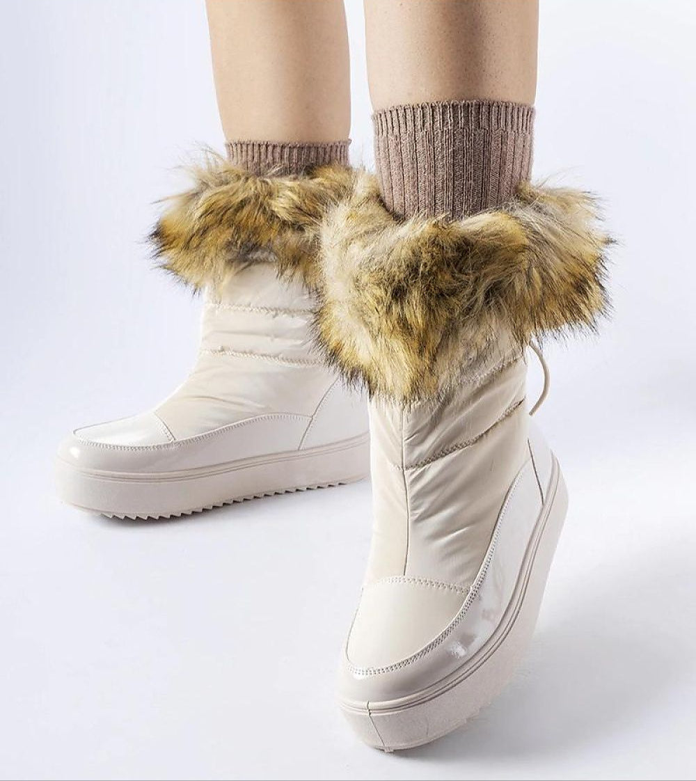 Fashionable winter boots with fur lining, showcasing cozy and warm design for cold days.