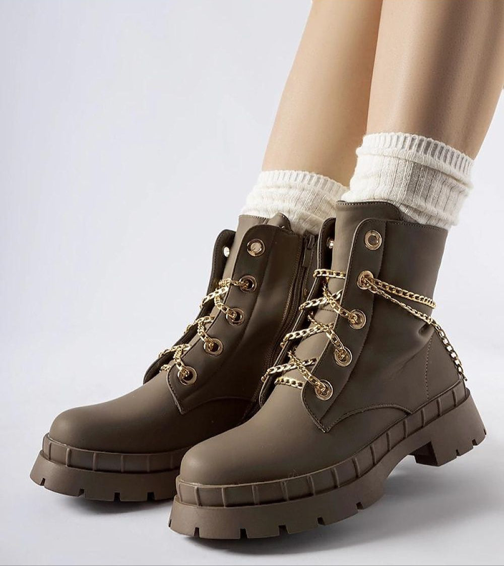 Brown Alcinéa Chain-Detail Insulated Ankle Boots with chunky sole and gold chain, styled with white socks, perfect for fall fashion.