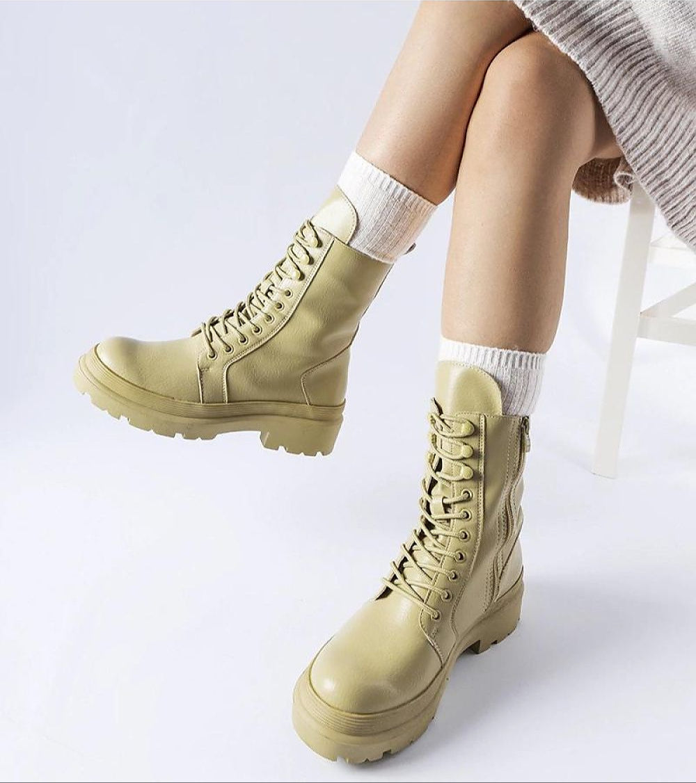 Woman wearing Vereliane Winter Boots with a high ankle silhouette and side zipper for stylish cold-weather protection.