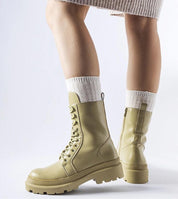 Person wearing beige Vereliane Winter Boots with high ankle coverage and flat heel, showcasing contemporary style and cold-weather protection.