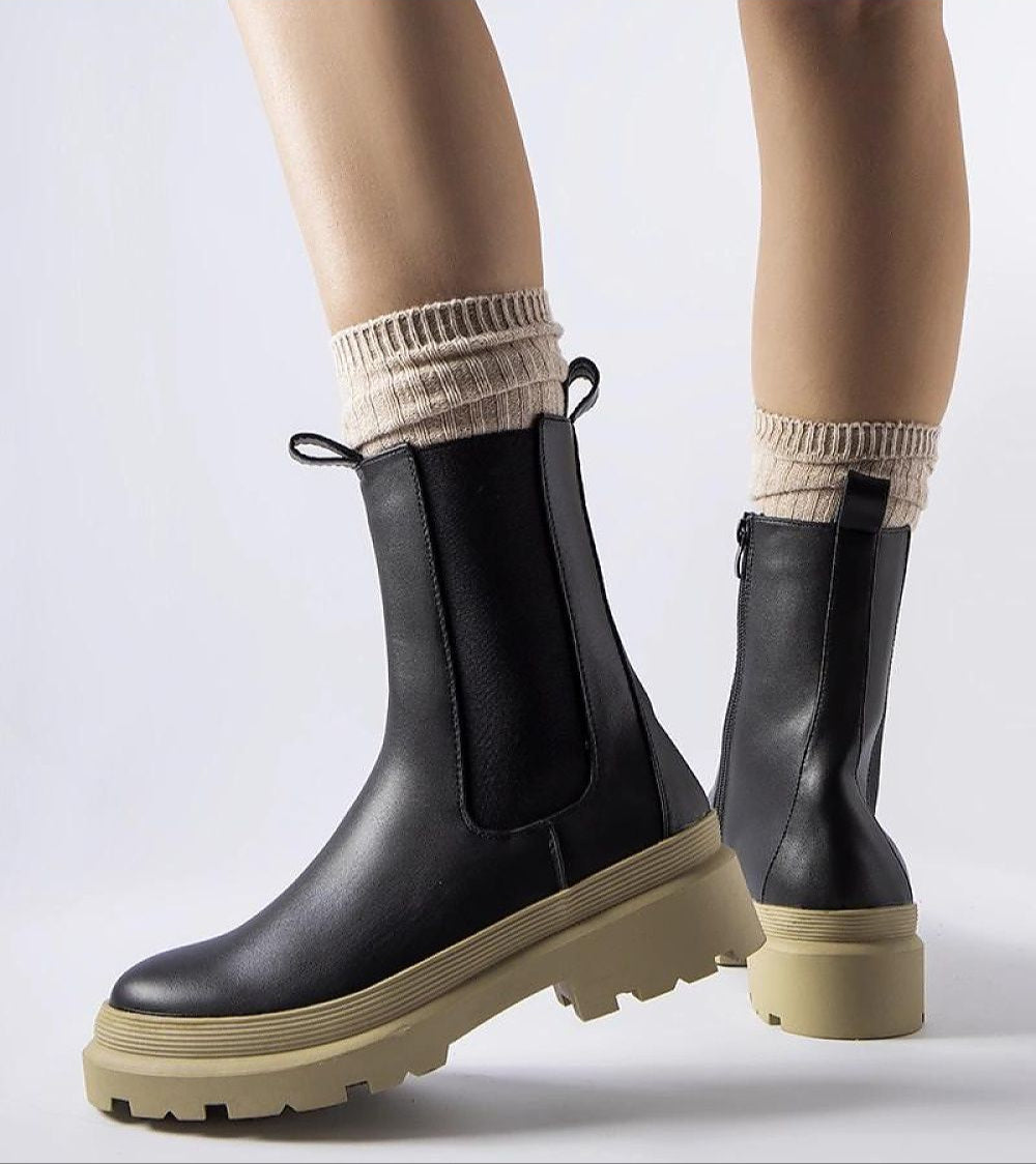 Vereliane Ankle Boots in black vegan leather with olive sole, showcasing modern minimalist style and winter readiness.