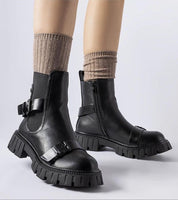 Black insulated heel boots Marvéra with chunky sole, elegant style, and warm lining for winter, worn with beige socks.