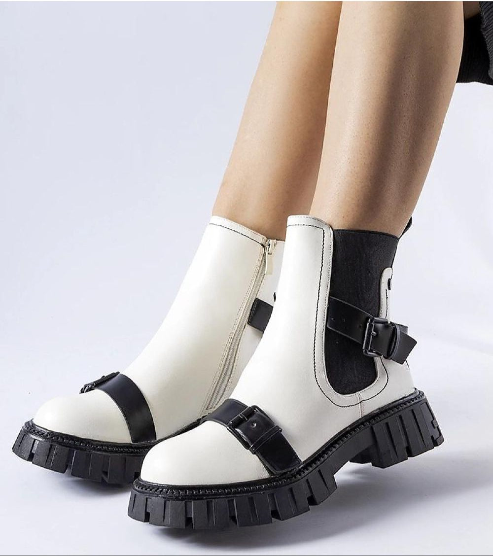 Stylish insulated heel boots with chunky sole in white and black leather, perfect for winter fashion and comfort.