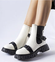 Stylish insulated heel boots with chunky sole in white and black leather, perfect for winter fashion and comfort.
