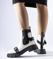 White insulated heel boots with chunky black sole, stylish ankle design, suitable for winter wear. Ideal for fashion and warmth.