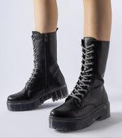 Black lace-up eco leather insulated winter boots with mid-high silhouette and chunky sole, perfect for warmth and style.