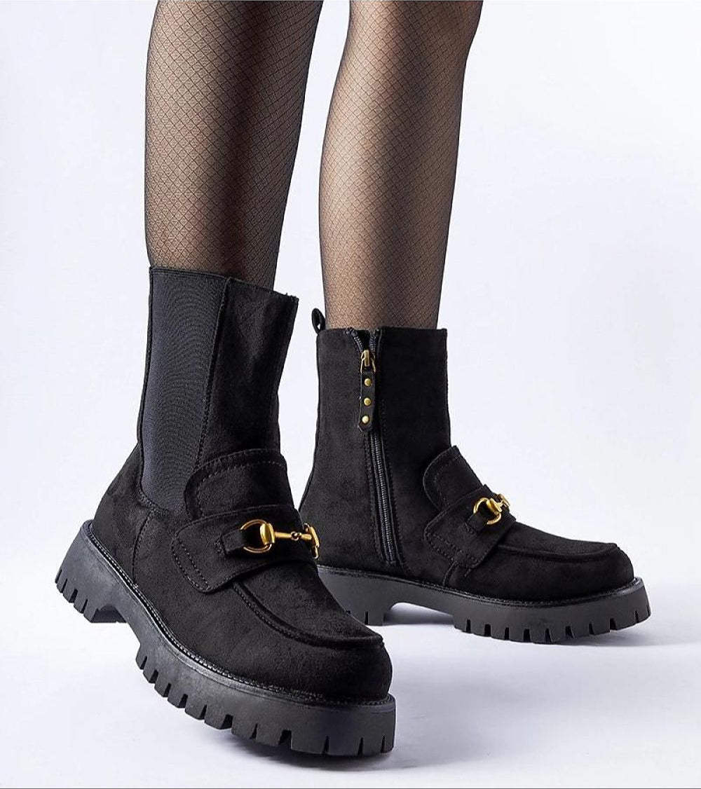 Women's black ankle boots with buckle and side zip, featuring rugged sole and stylish design.