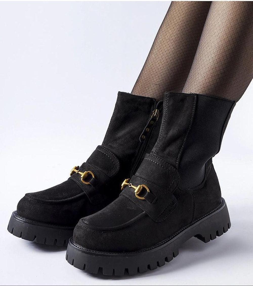 Black ankle boots with buckle detail, round toe, and flat heel, crafted from eco leather for cold-weather comfort and style.