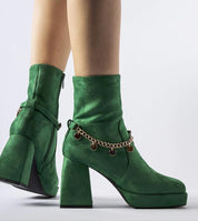 Green square-toe ankle boots with 9 cm heels, eco leather, and ankle pendant detail, showcasing bold design and winter elegance.