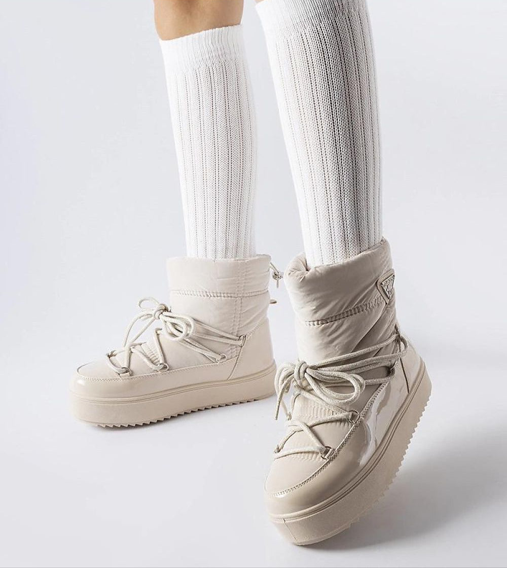 Tharima insulated slip-on snow boots with water-resistant rubber, cozy lining, and flexible ankle band, ideal for winter comfort and style.