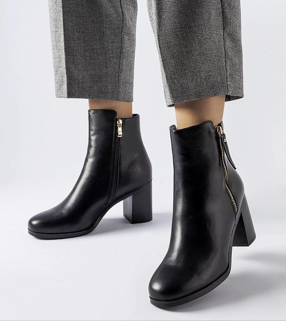 Lyvarra insulated high-heel boots in black eco leather with side zipper, offering stylish winter warmth and elongated silhouette.