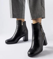 Lyvarra insulated high-heel boots in black eco leather with side zipper, offering stylish winter warmth and elongated silhouette.