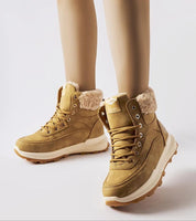 Esmyelle insulated winter sneakers in eco leather, with a 5 cm rubber sole and lace-up design for stability and comfort in cold weather.