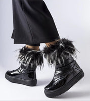 Lureysa Big Star insulated snow boots with patent shine, eco leather, tall shaft, and fur trim, worn by a person in black pants.