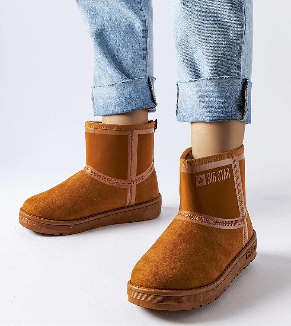 Person wearing Silvoya Big Star insulated snow boots with eco leather and rubber sole, paired with rolled denim jeans.