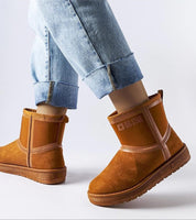 Person wearing Silvoya Big Star insulated snow boots with eco leather, showing slip-on design and rubber sole for winter grip.