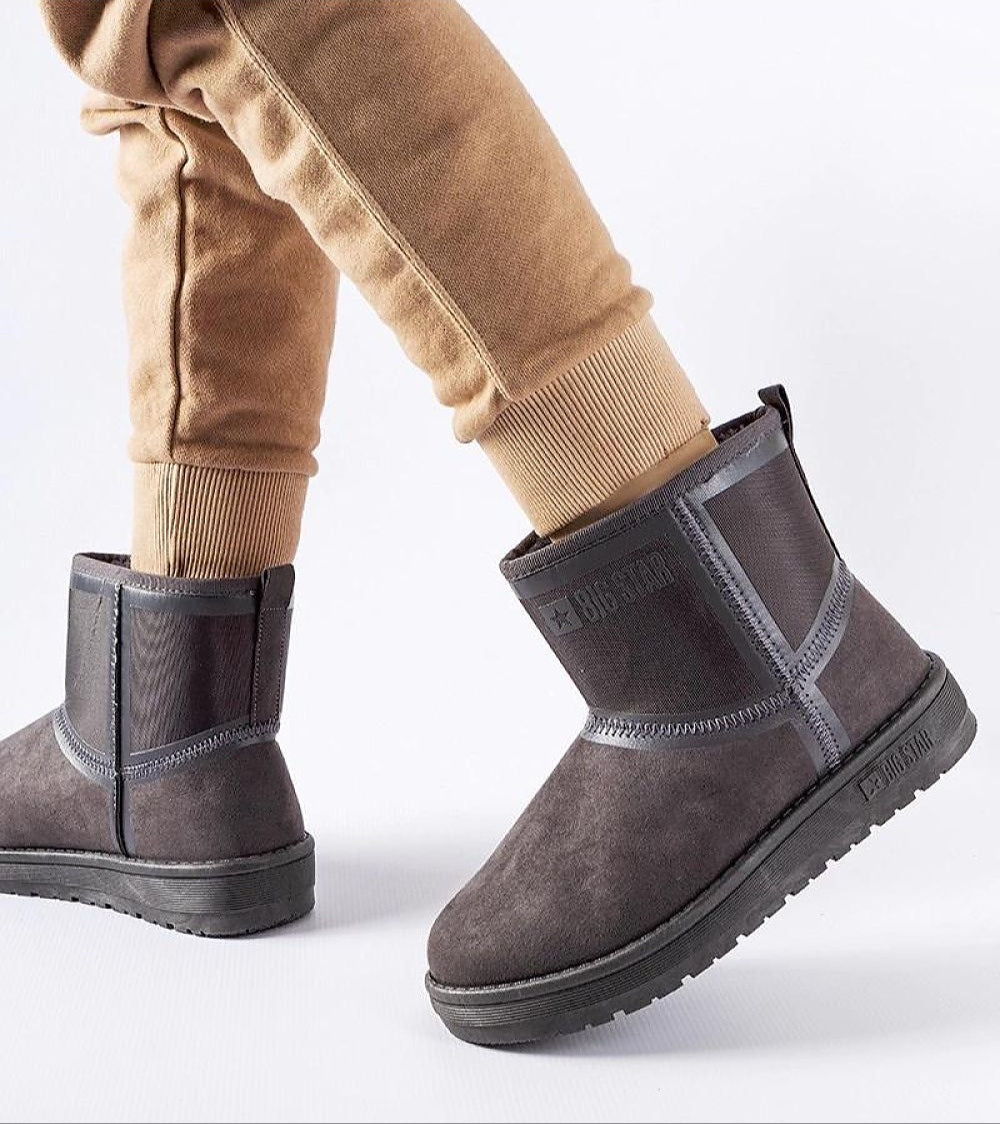 Person wearing ankle-high Arvessa Big Star low-heel snow boots in eco leather with brown pants, showcasing durable winter footwear.